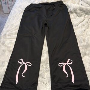 Black sweatpants with pink bowtie at the bottom
